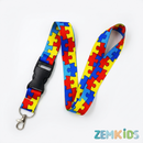 Cordão de identificação autismo com tema quebra-cabeça colorido da Zem Kids, com porta-crachá rígido para segurança e fácil uso.